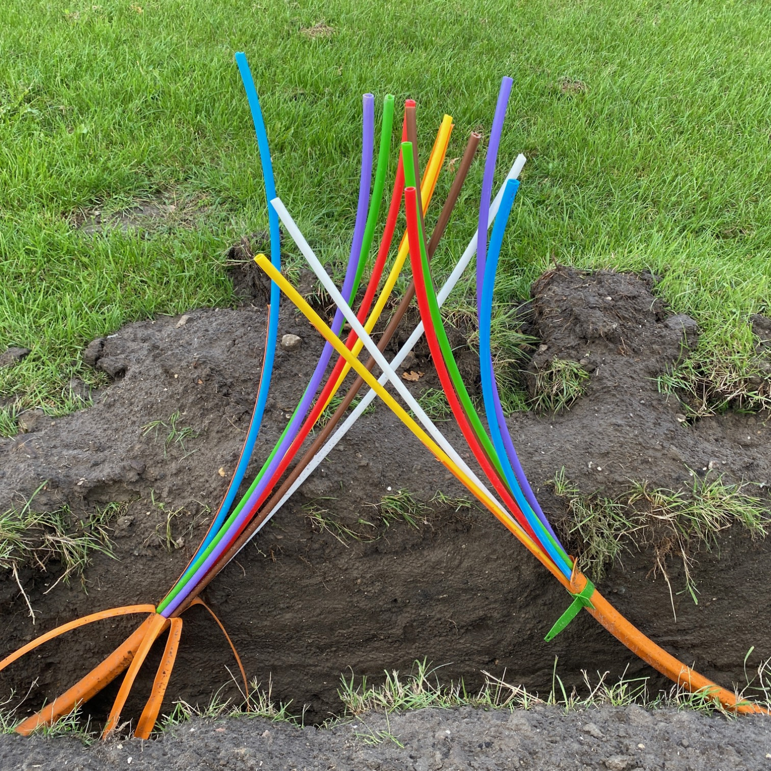 Een oranjekabel die uit meerdere kleuren bestaat. Hij is doorgeknipt of moet nog aan elkaar? Deze foto staat voor de verandering en wijst omhoog naar de nieuwe richting 